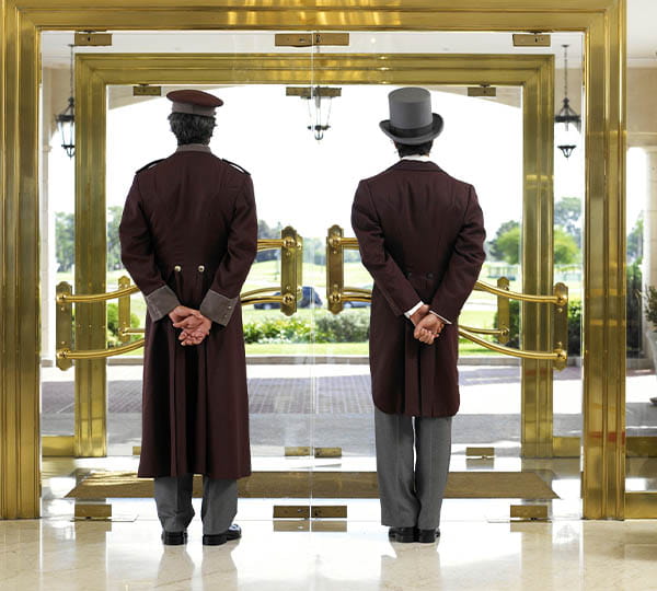 Two bellhops waiting at the door
