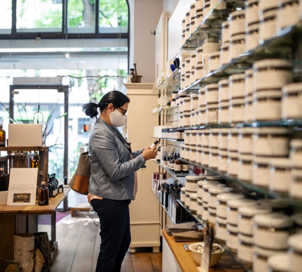 Woman wearing face mask while browsing in store