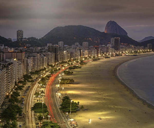 Beach view at night lit up by street lights