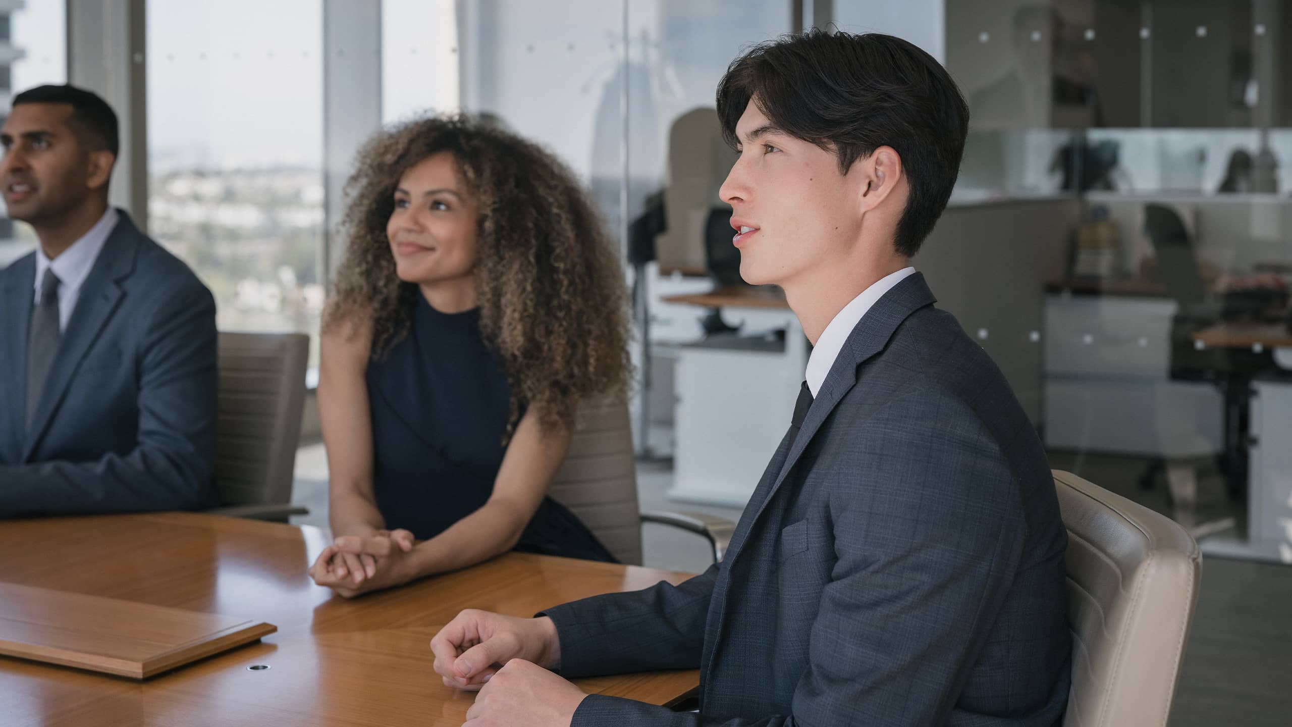woman speaking to man at computer monitor