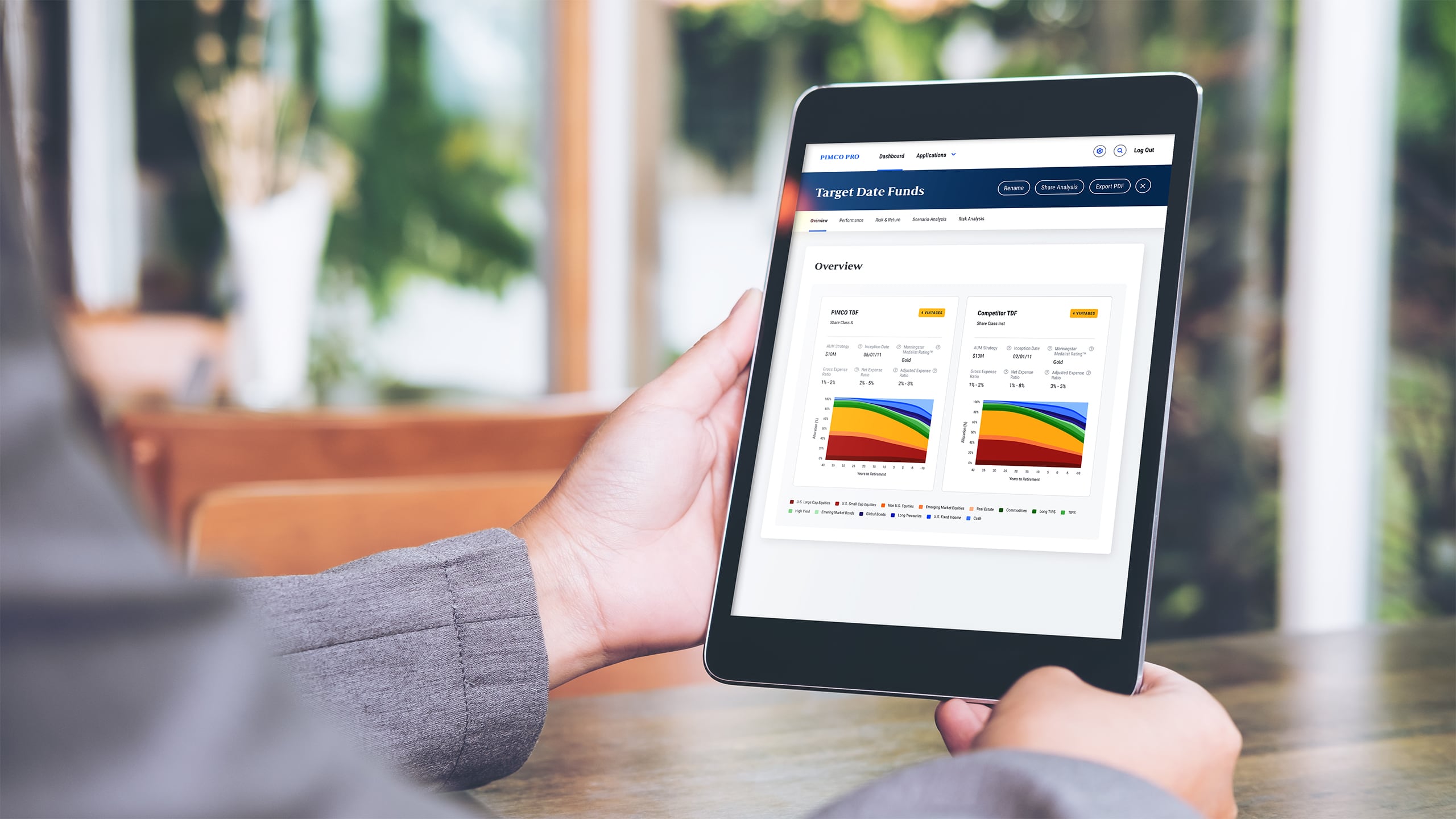 Person holding a tablet looking at fund data.